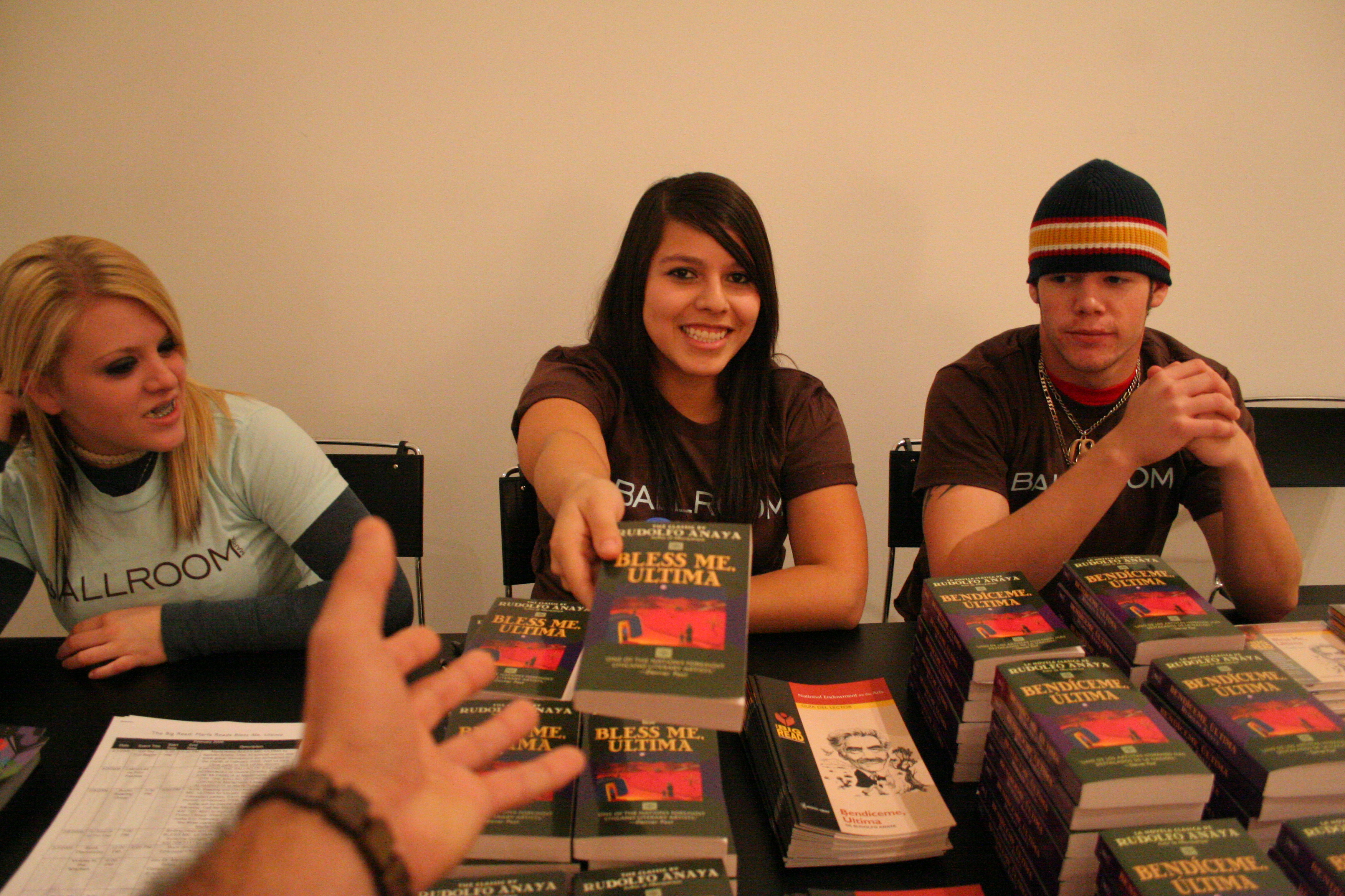 Students giving away Bless Me, Ultima at the Big Read kick-off. Photo by Fred Covarrubias.